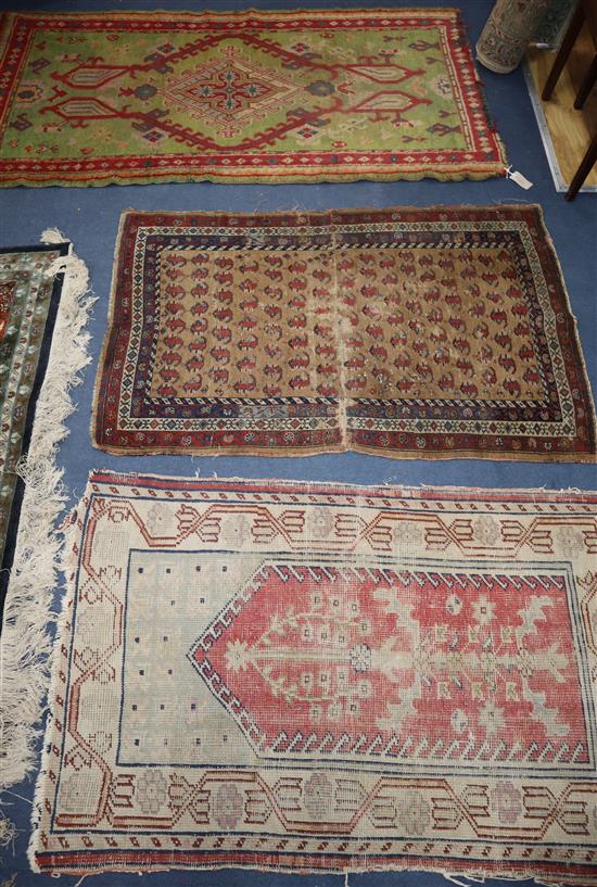 A Turkish green ground rug, 178 x 95cm, a worn runner and two other rugs